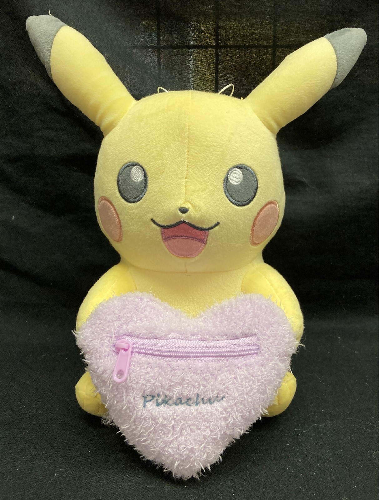 Pikachu holding a hot sale heart plush
