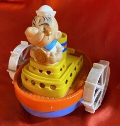 A boat with a wind-up toy with a turtle mark